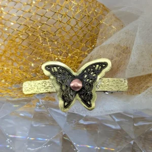 barrette papillon or avec une estampe